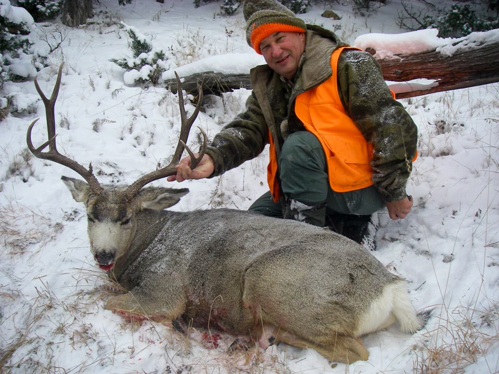 hunter poses with his mule deer trophy