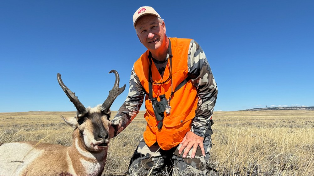 a hunter poses with his antelope harvest