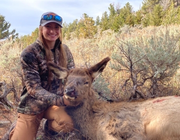 Female hunter posing with her cow elk