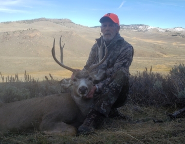 Hunter posing with his mule deer