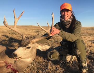 A female hunter with her mule deer